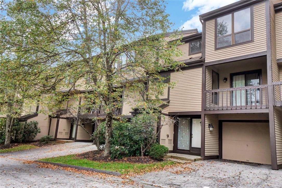 Front door and driveway/garage. 2nd floor balcony to kitchen, 3rd floor bedroom window.