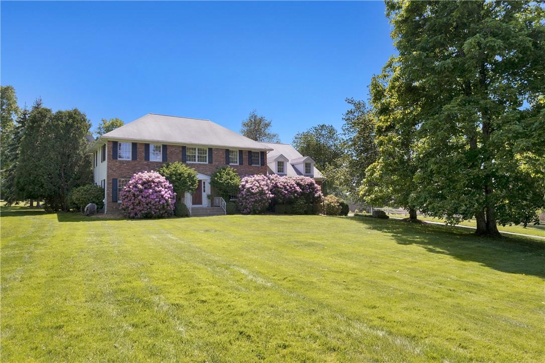 Colonial-style house with a front yard