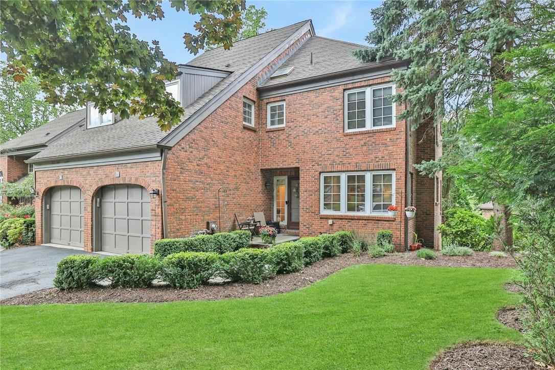 View of front of house featuring a garage and a front yard