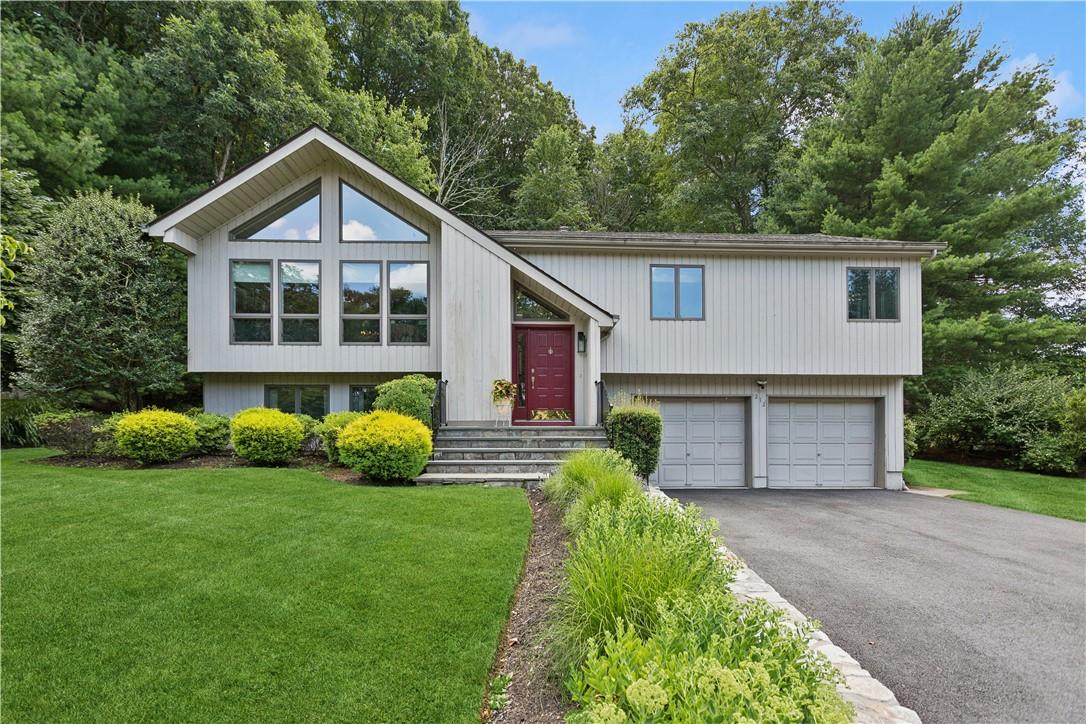 Raised ranch with a garage and a front lawn