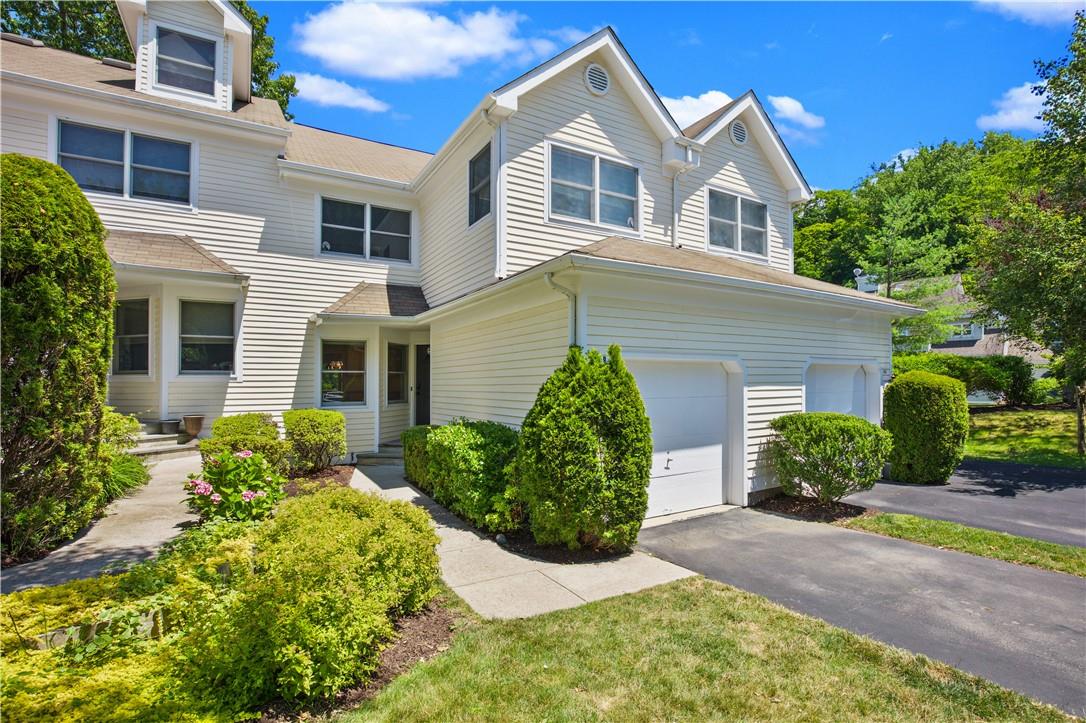 Townhome / multi-family property featuring a garage