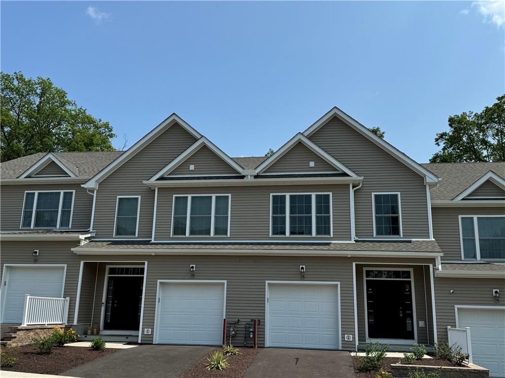 View of property featuring a garage
