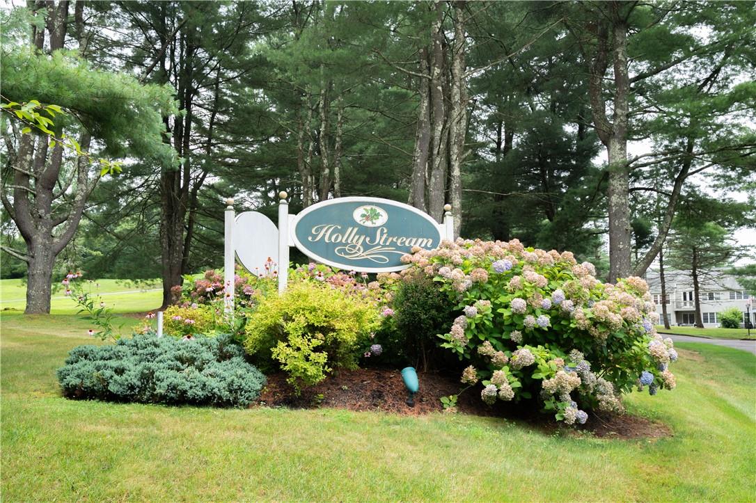 Community / neighborhood sign featuring a yard