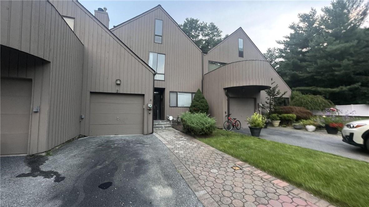 View of front facade featuring a garage