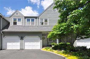 Richmond Hill enjoys 2 car attached garage and lush landscaping.