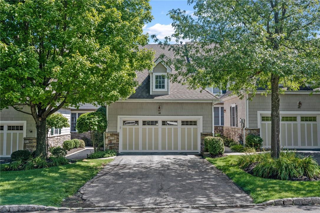 View of front of house featuring a front lawn and a garage
