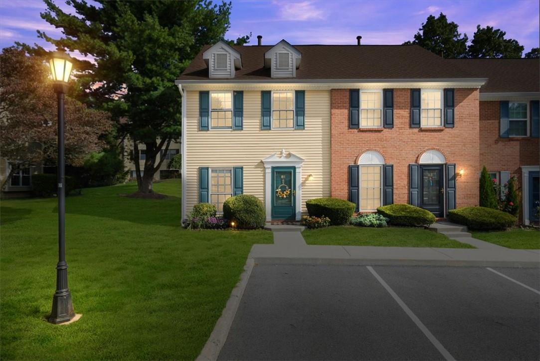 Colonial inspired home with a yard