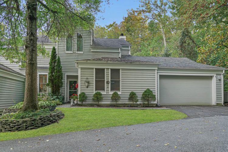 View of front of home with a garage and a front yard