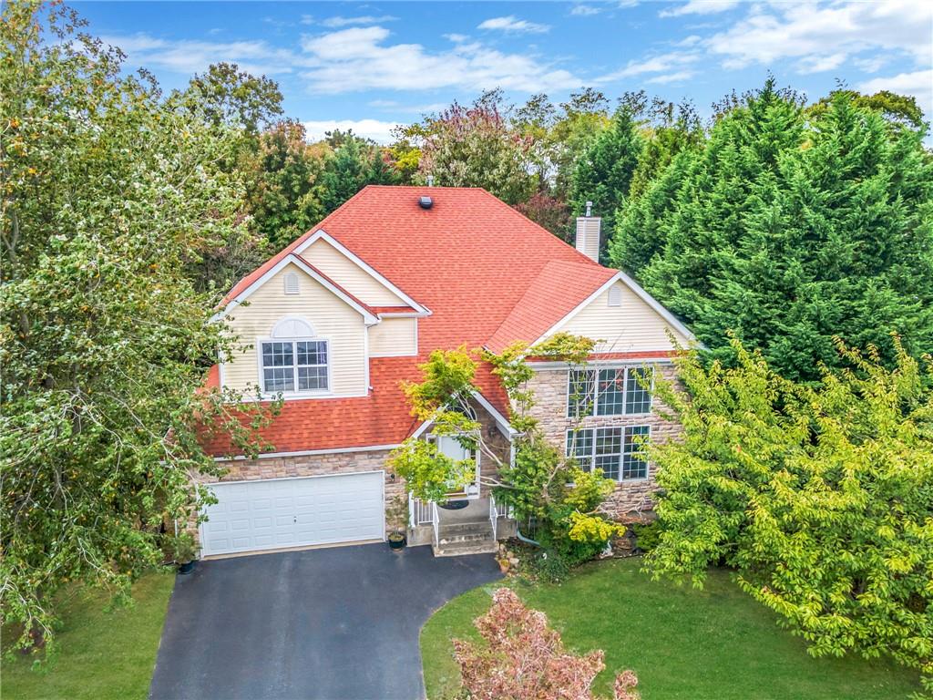 View of front of house with a garage and a front lawn