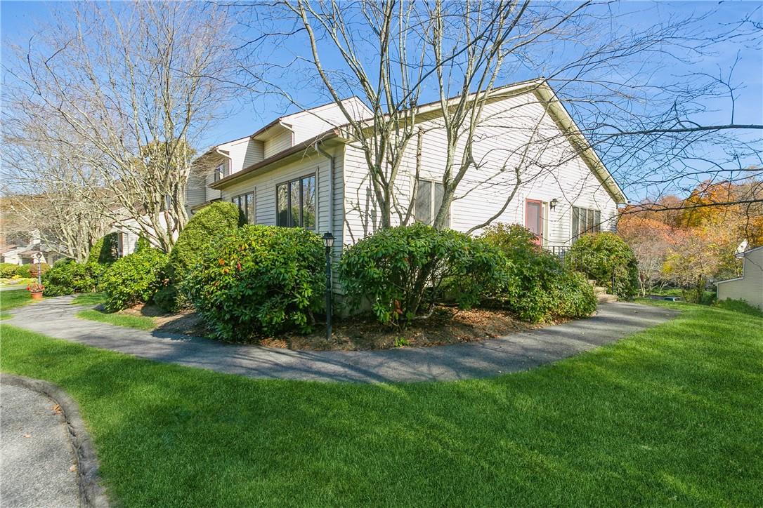 View of property exterior with a lawn