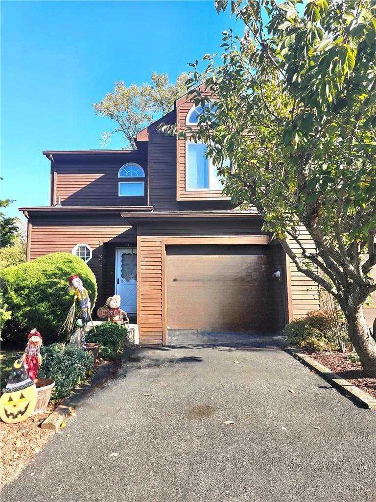 View of front of home with a one car garage.