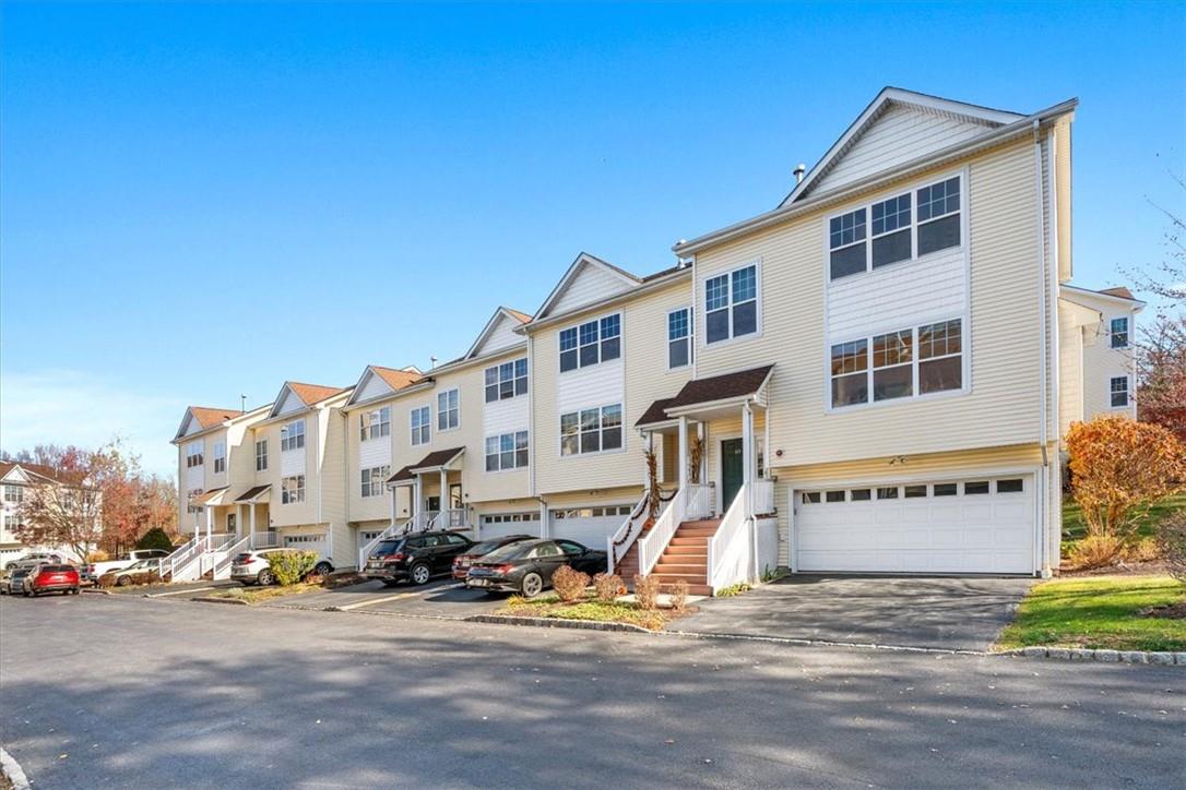 Townhome / multi-family property featuring a garage