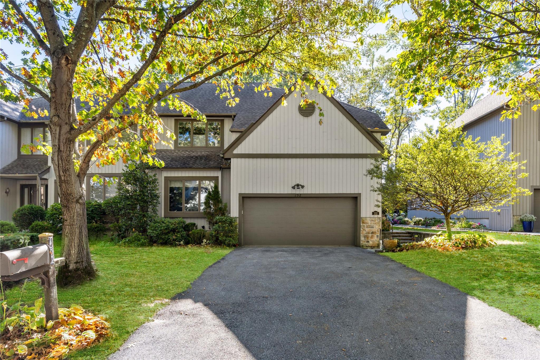 View of front of house with a front yard and a garage