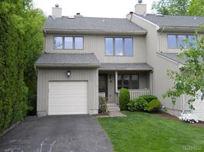 Front view of this pristinely renovated, mint condition Tri-level clapboard Townhouse in desirable Rye Wood Farms.