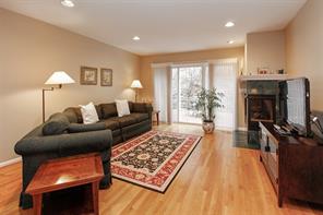 Living room with fireplace and doors to deck.