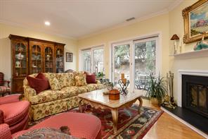 Living room opens to private back patio accessed  thru one of two sets of sliding doors. In colder weather a wood burning corner fireplace creates a comfortable place to watch the snow fall.