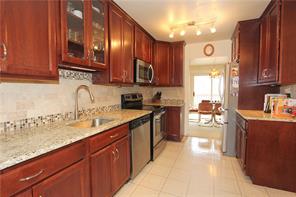 NEW EAT IN KITCHEN COMPLETE WITH 42 INCH CHERRY CABINETS, LOADS OF GRANITE COUNTERSPACE, NEW STAINLESS APPLIANCES, AND TILE BACKSPLASH WITH ROOM FOR LARGE TABLE