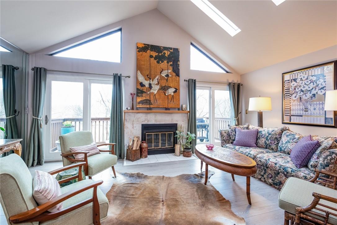 Marble surround fireplace with newer sliding doors overlooking peaceful and private setting. Lots of natural light with two skylights.