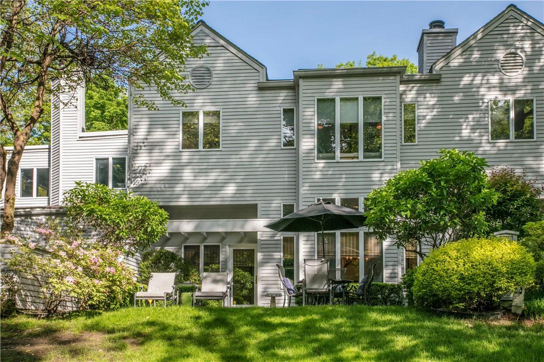 Let's start with the rear view of this beautifully updated home in the Beechwood community in the Scarborough section of Briarcliff Manor. The large rear patio provides privacy and sunshine. Plus a scenic view of the pond.