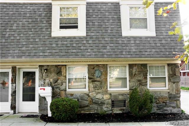 Natural Stone Front with Manicured Garden