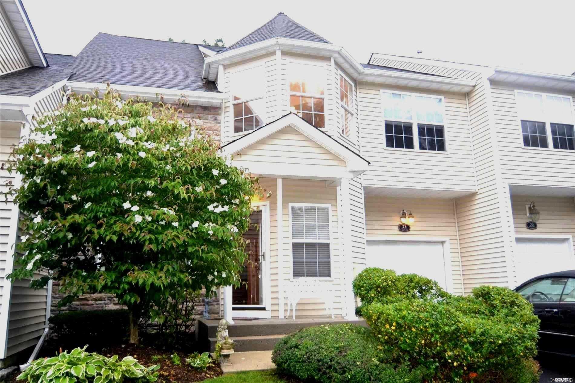 Landscaped front view w/oversize driveway