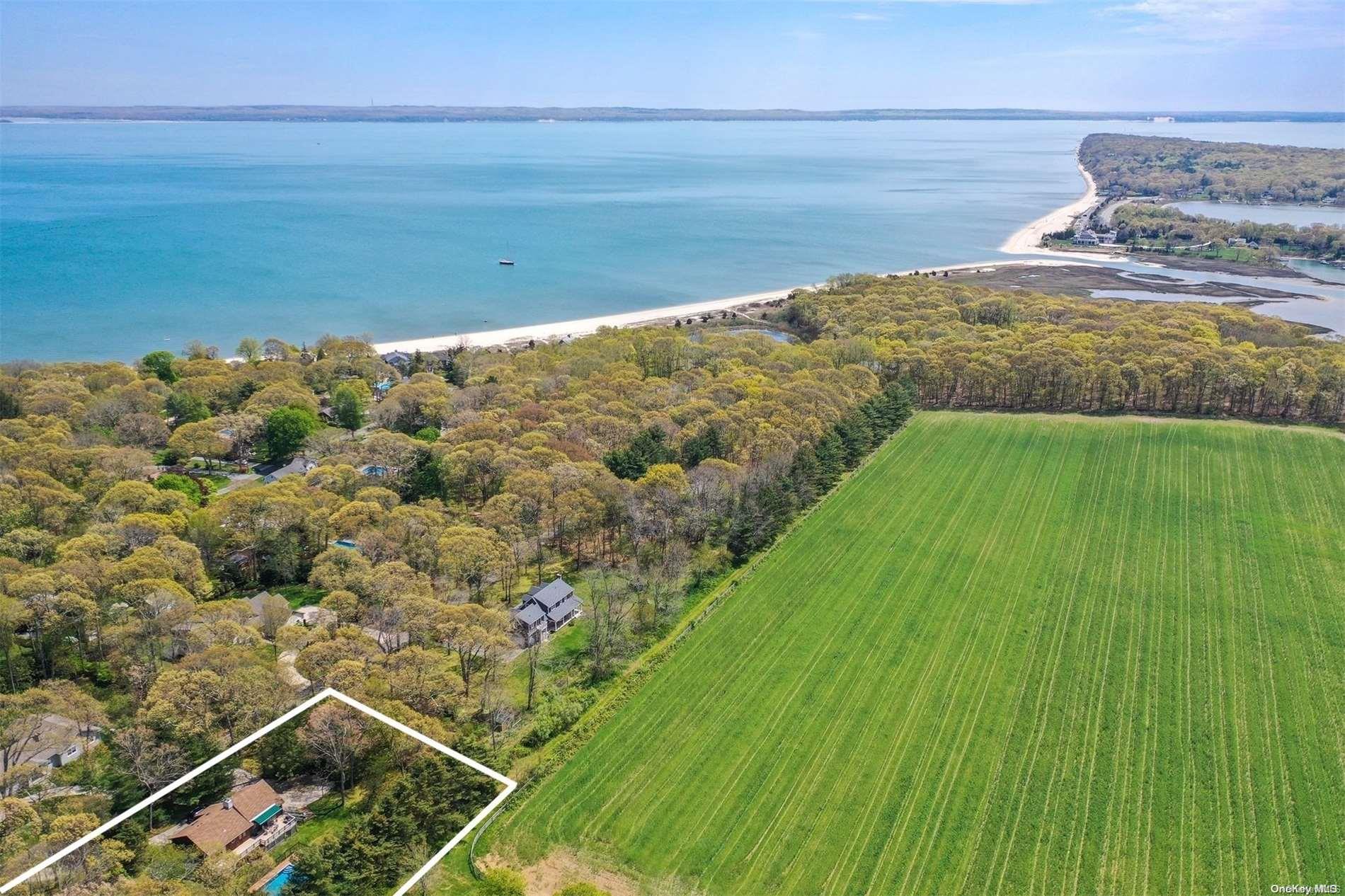 Bordered by farmland and short stroll to private sandy bay beach