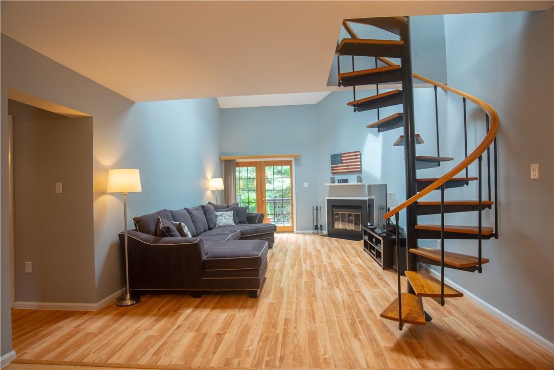 Welcome home! Gorgeous view of this stunning open space living room with beautiful spiral staircase that leads to the loft.