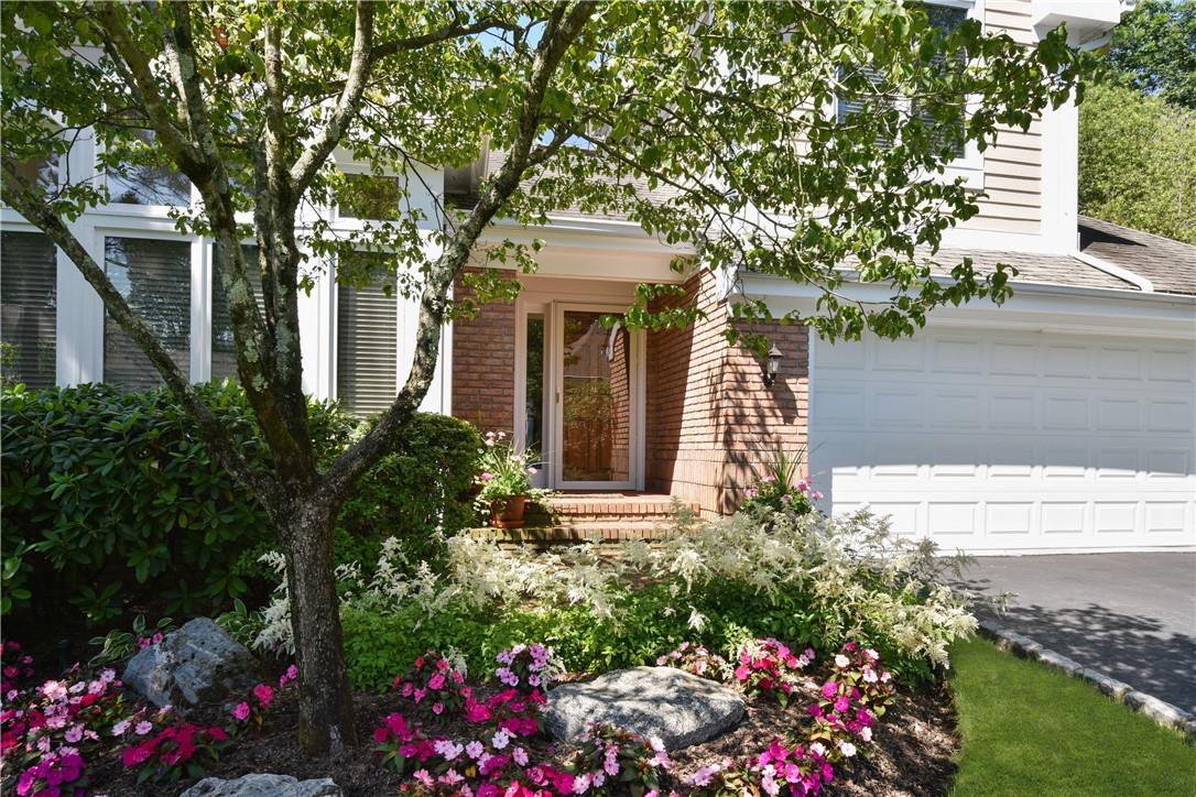 Enjoy the beautifully landscaped property at 8 Longledge Drive.