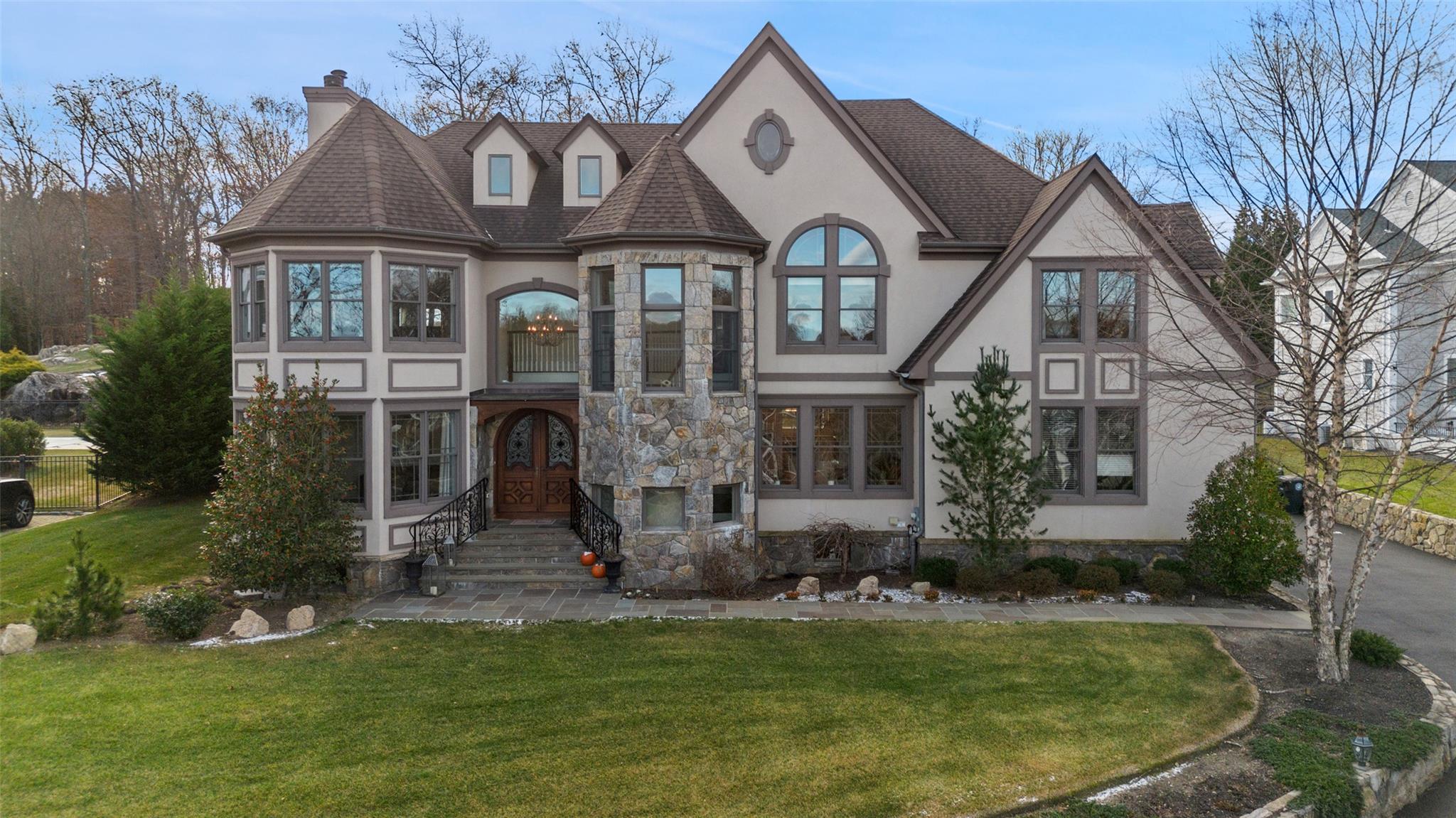 View of front of property with french doors and a front lawn