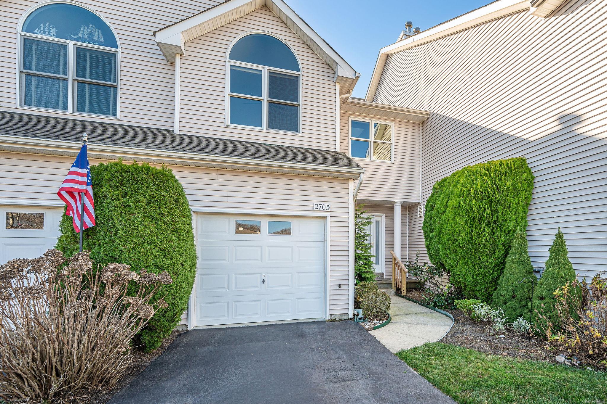 Townhome / multi-family property featuring a garage