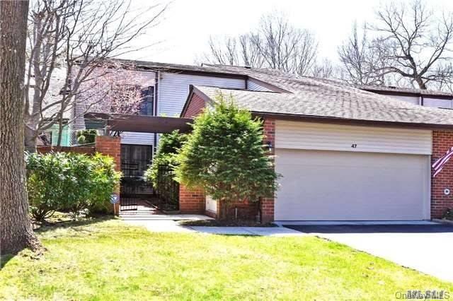 View of front of property with garage and  front lawn