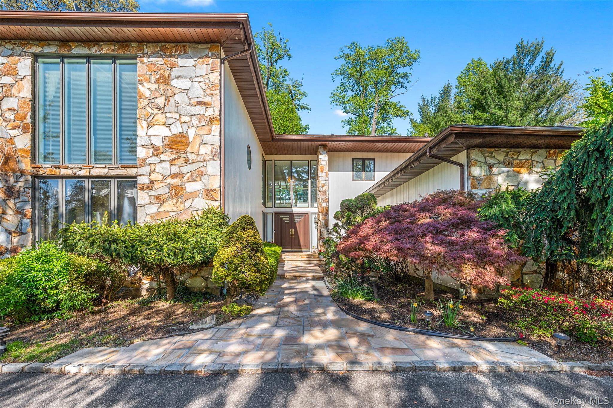 View of front of house with stone siding
