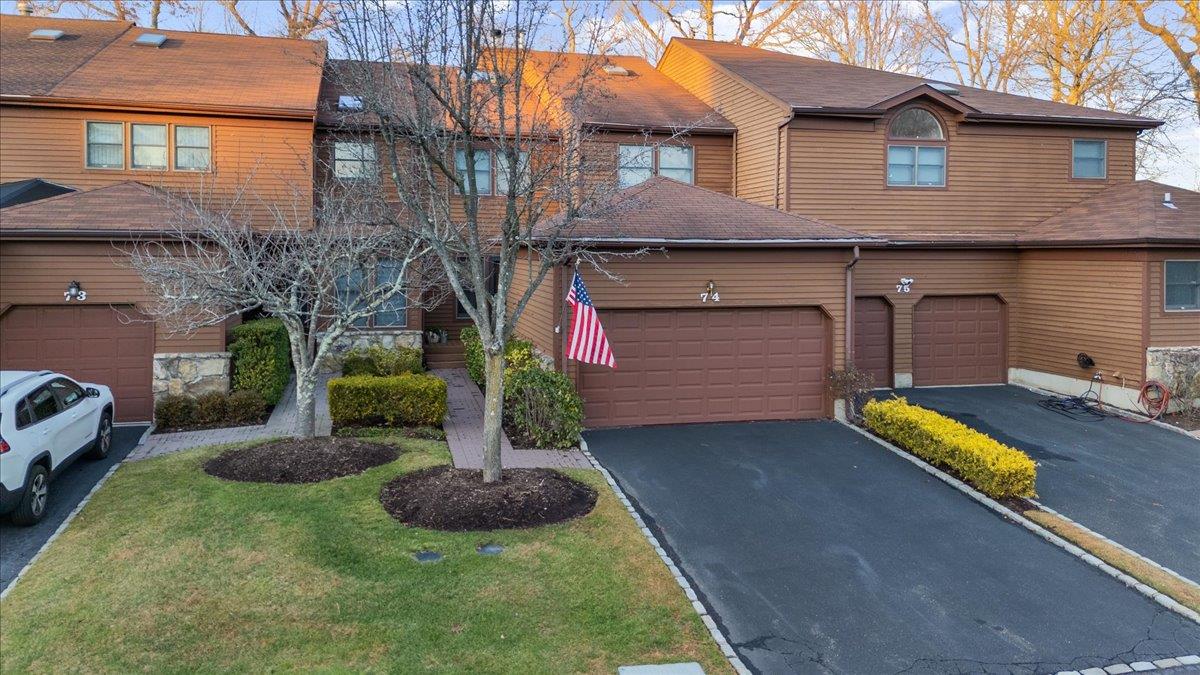 View of front of property featuring a garage and a front yard
