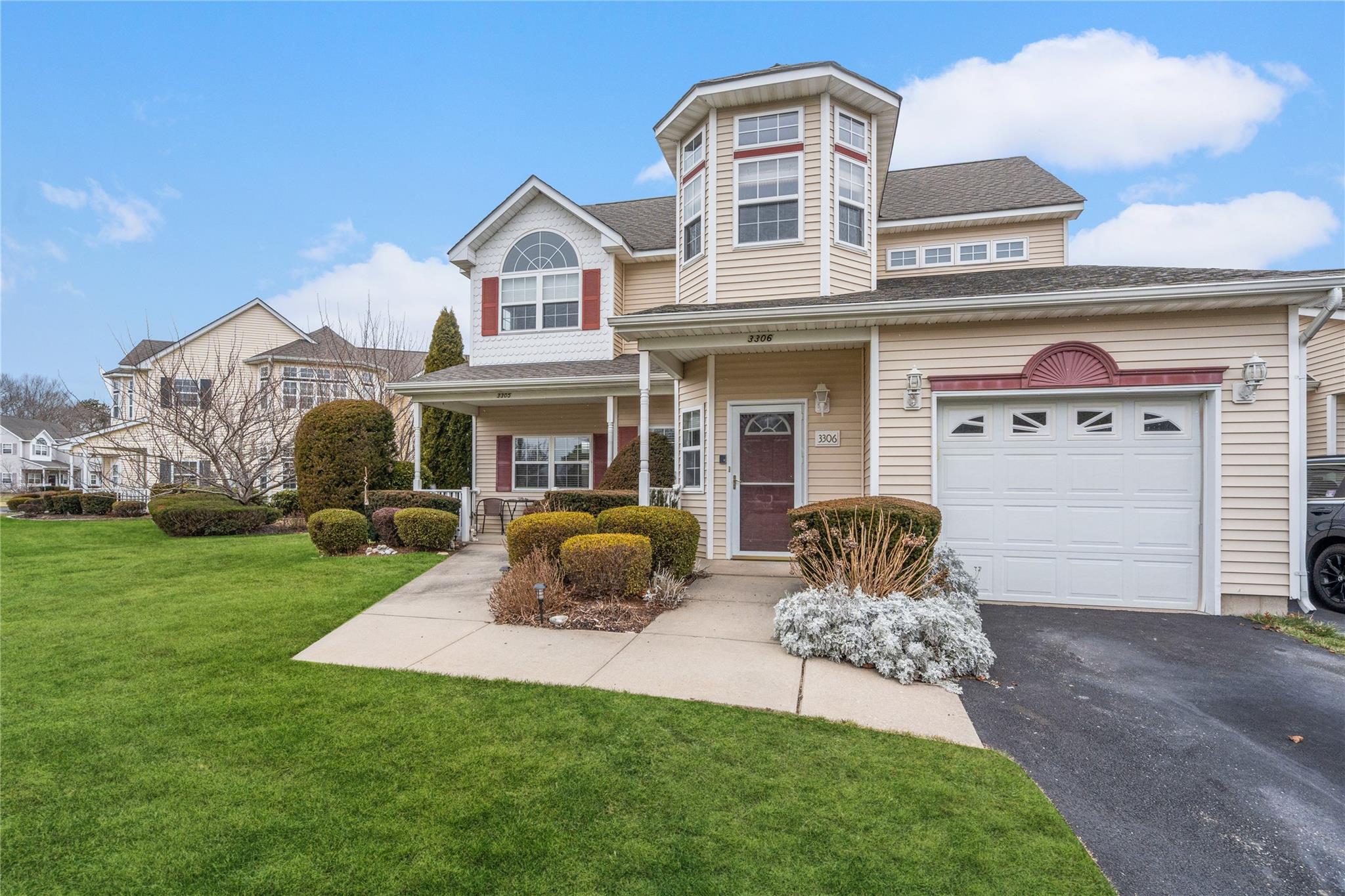 View of front of home with a garage and a front lawn