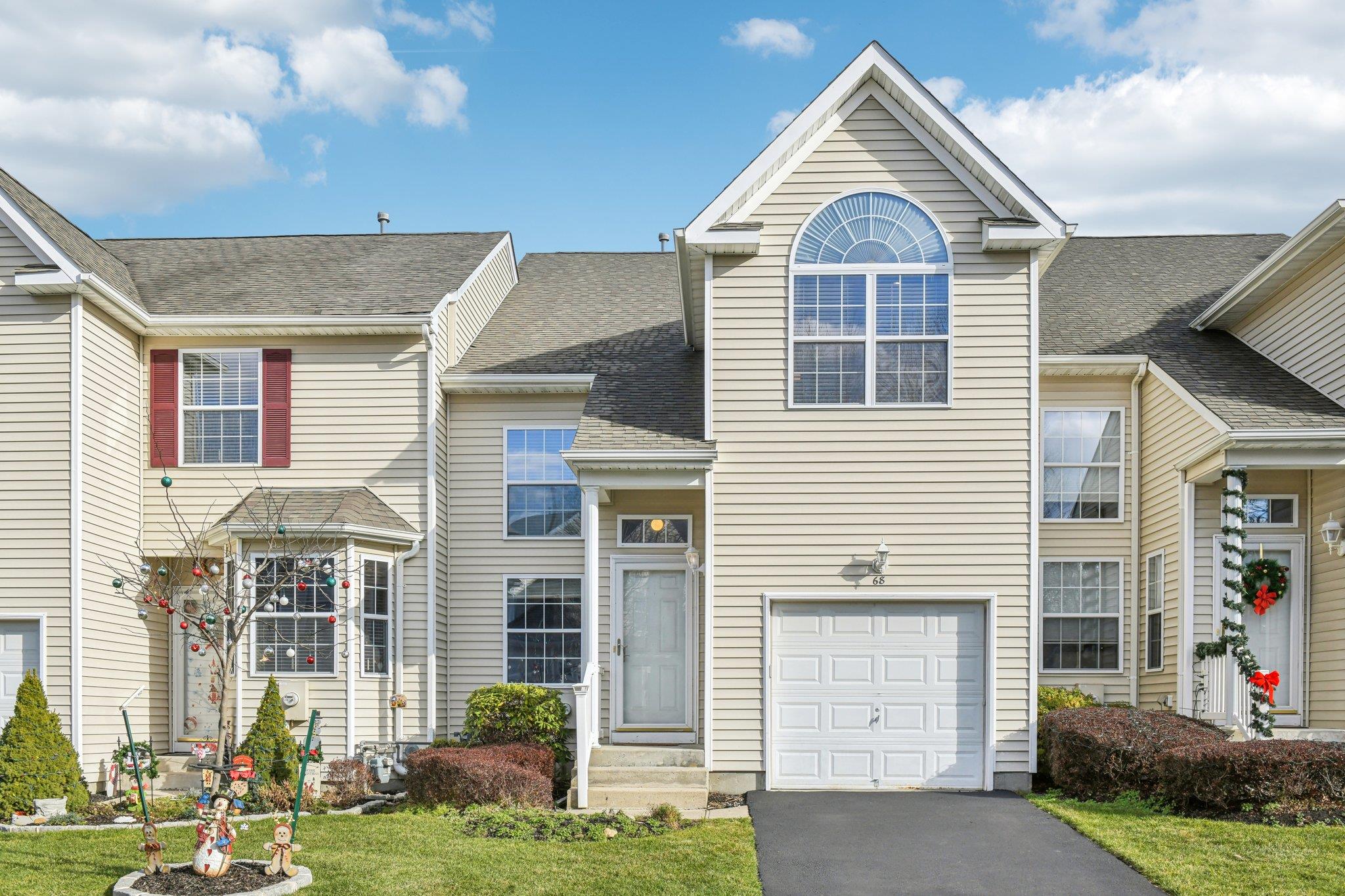 View of front of property with a front yard and a garage