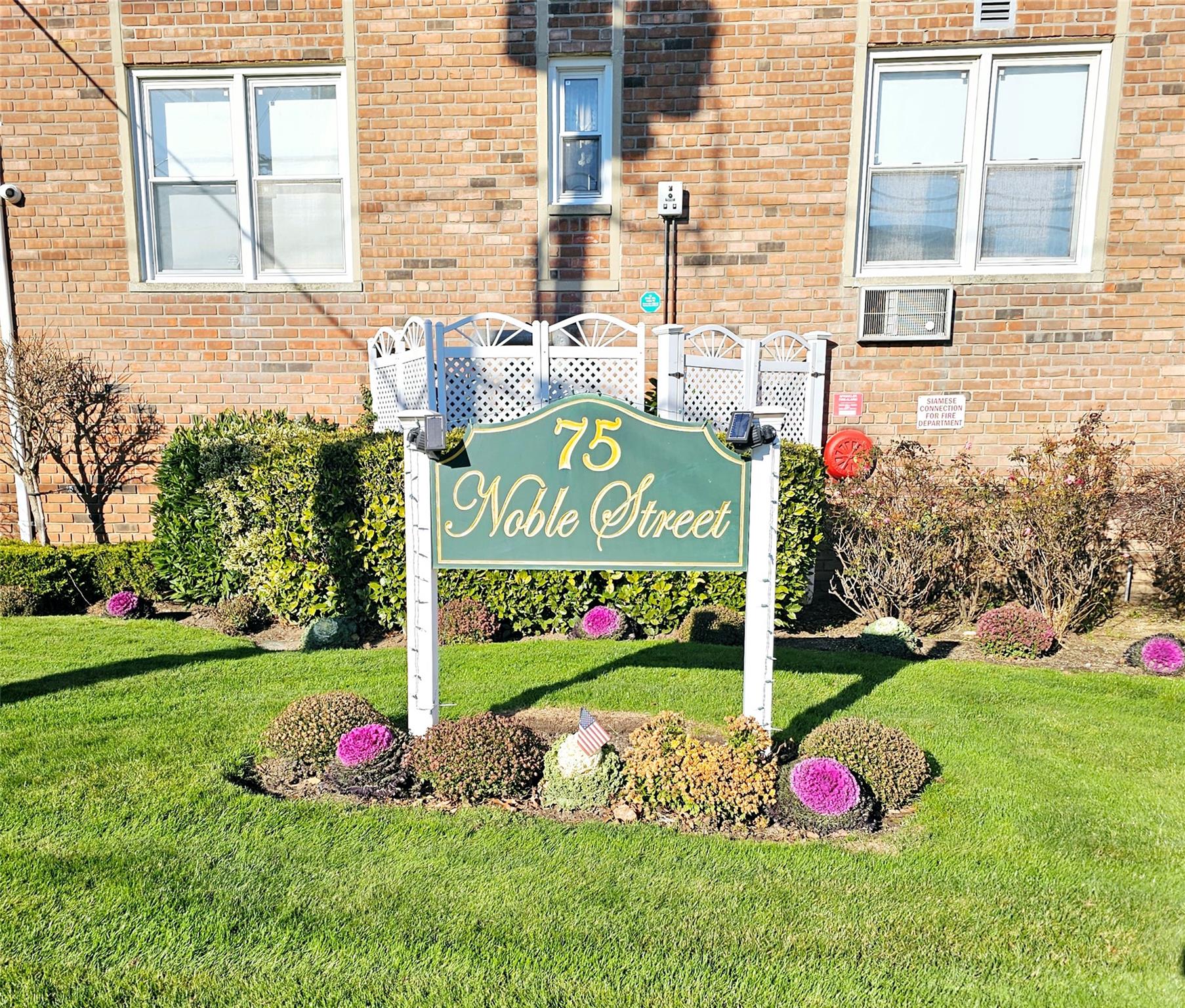 Community / neighborhood sign featuring a yard