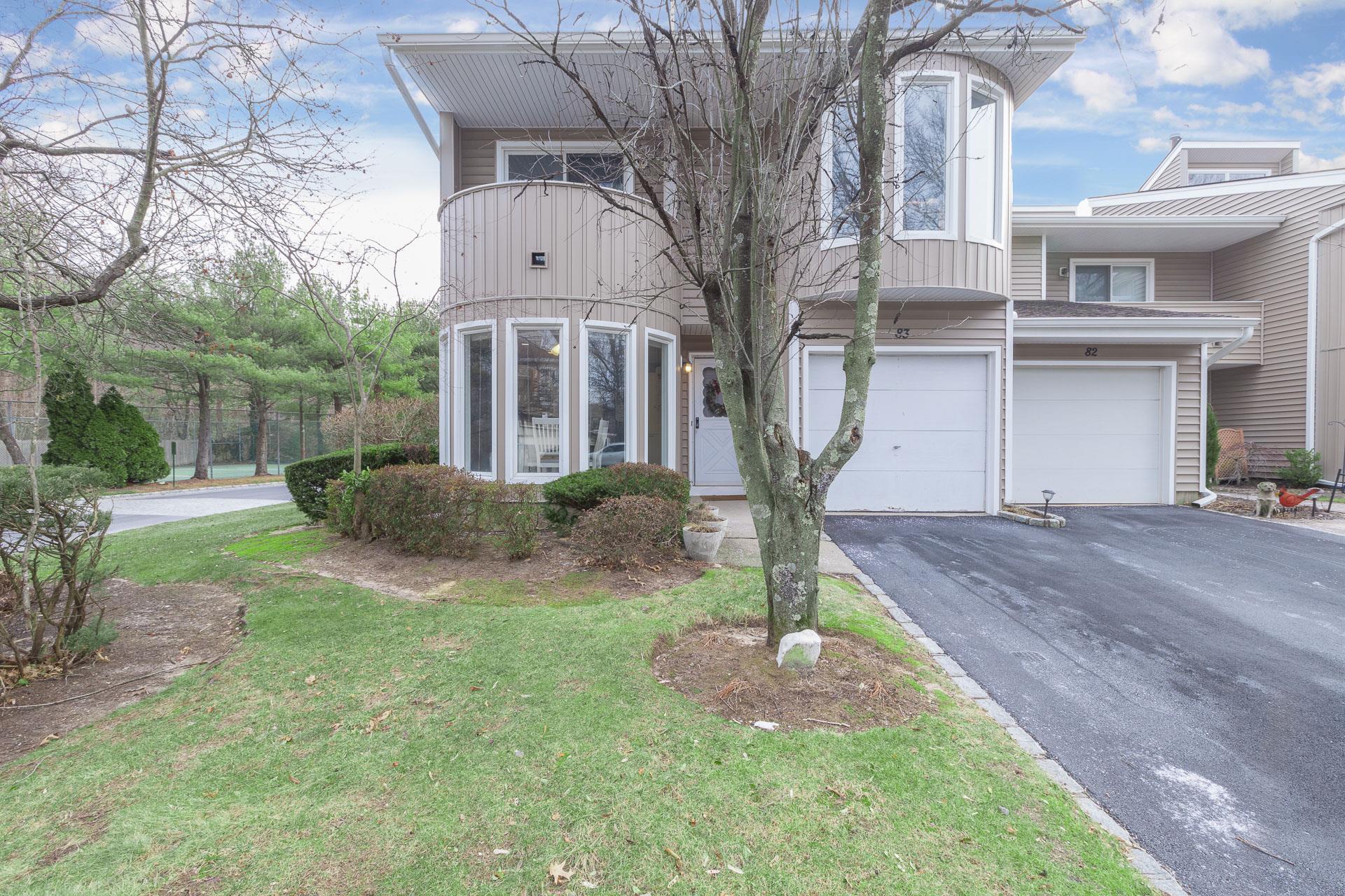 View of front facade with a front yard and a garage