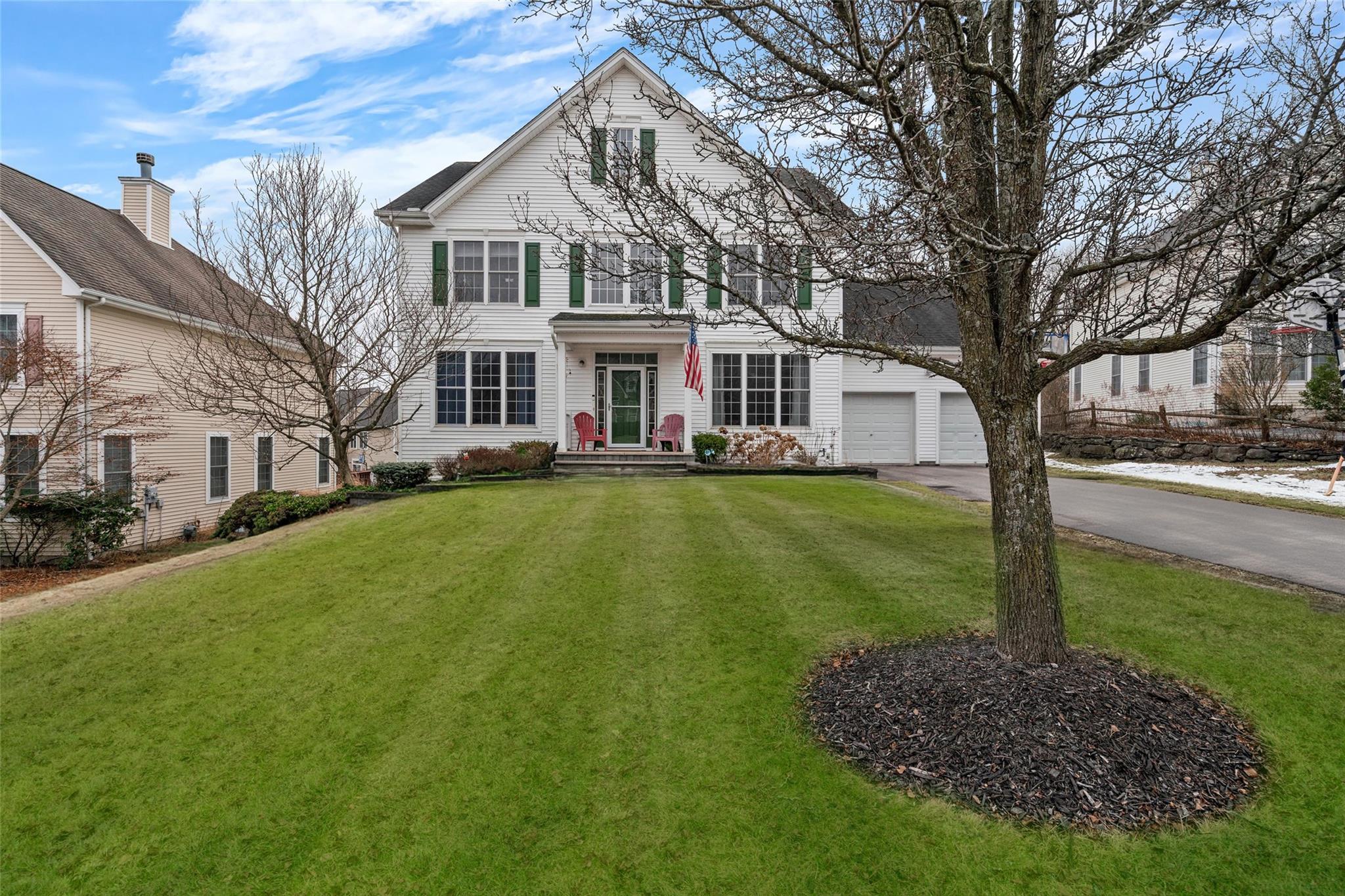 View of front of property with a front yard and a garage