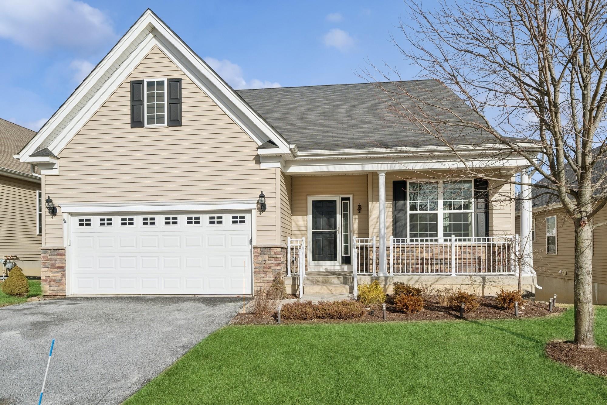 View of front facade with a front a porch, and a garage