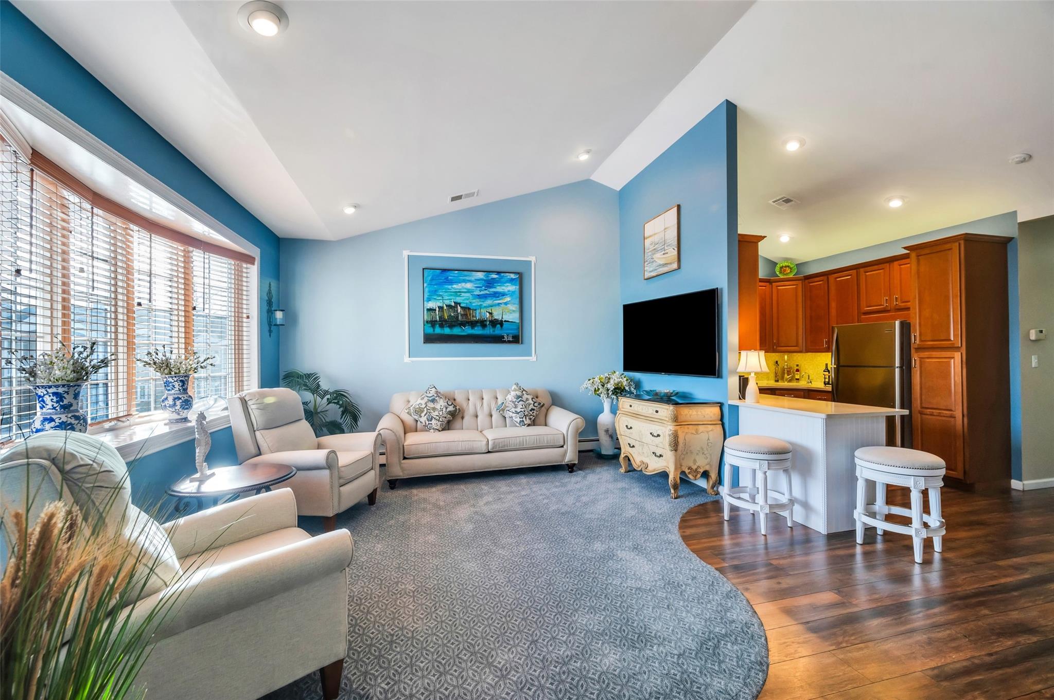 Living room featuring dark wood-type flooring and vaulted ceiling