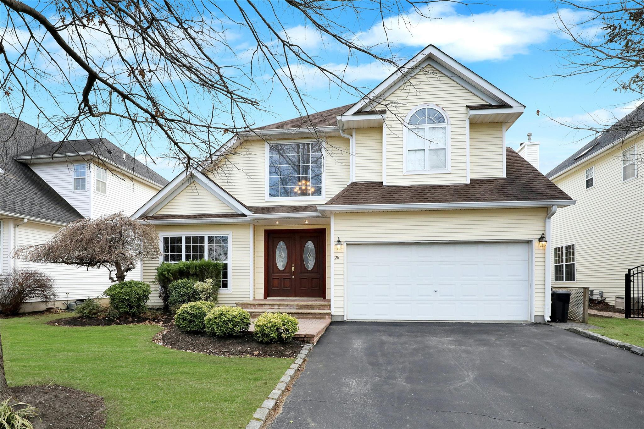 View of front of home featuring a garage and a front lawn