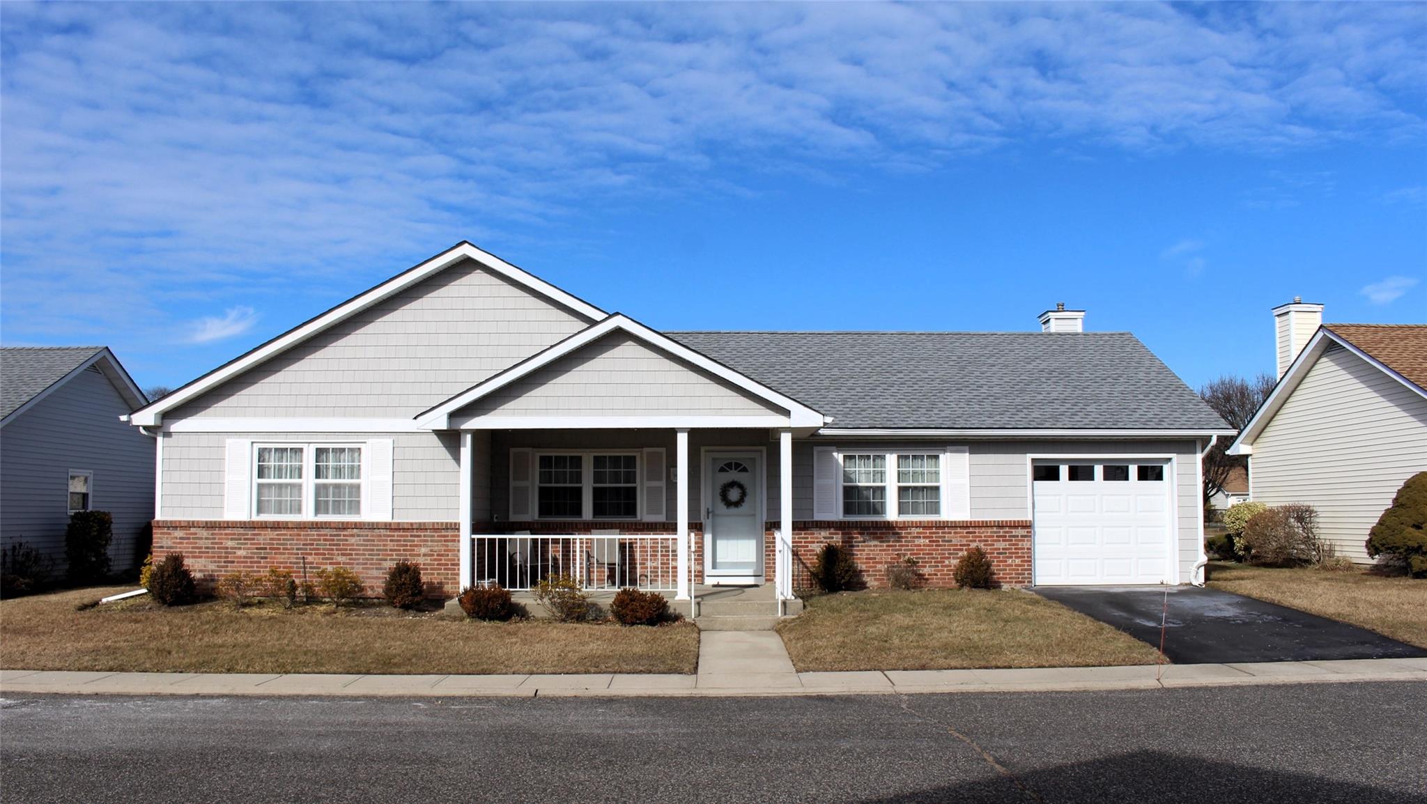View of front facade with a covered porch and a garage