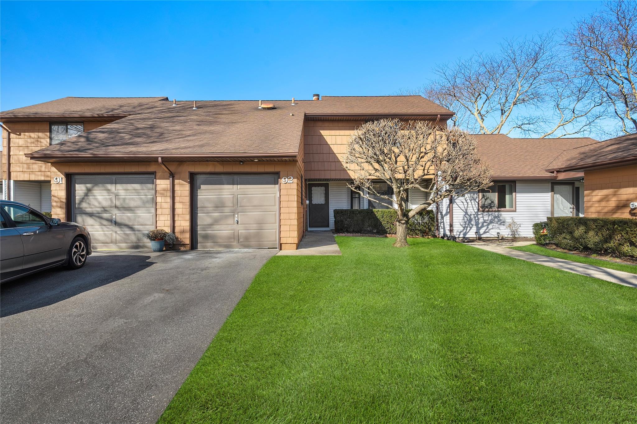 View of front of home featuring a garage and a front yard