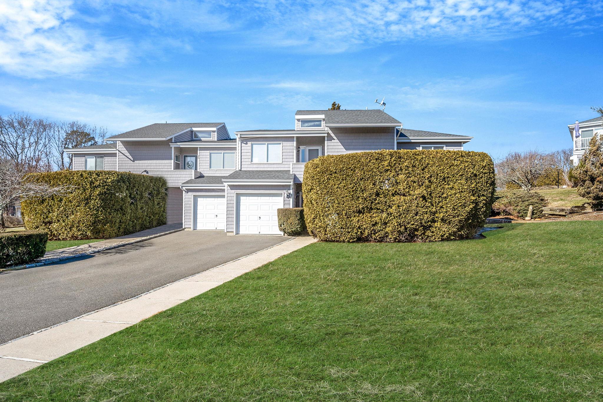 View of front of home with a garage and a front yard