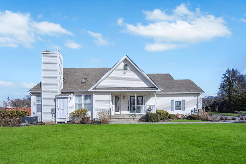 View of front of the home featuring a covered porch and front lawn