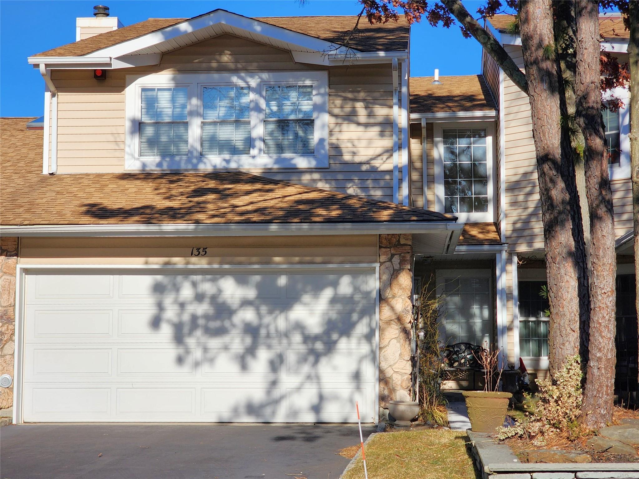 Front View featuring an attached 2 car garage.