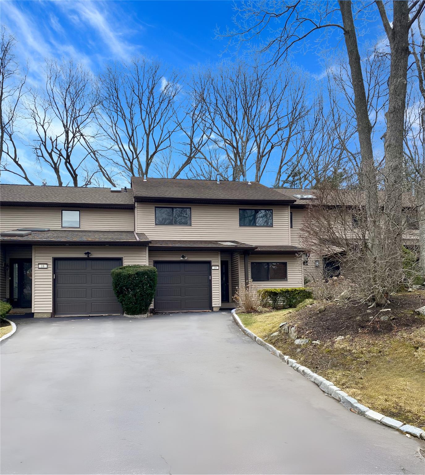 View of front of home with a garage and driveway