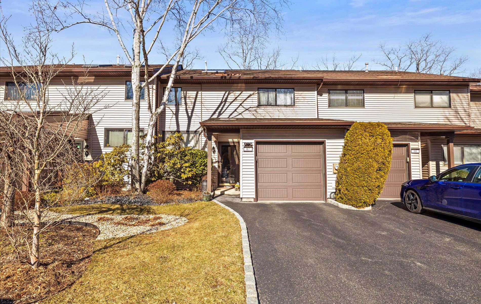 Multi unit property with aphalt driveway and a garage