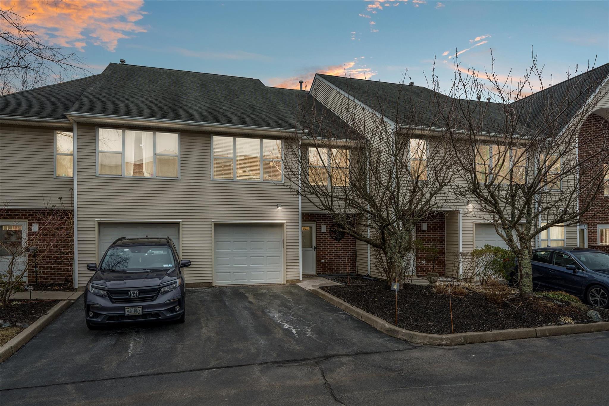 View of property with driveway and a garage