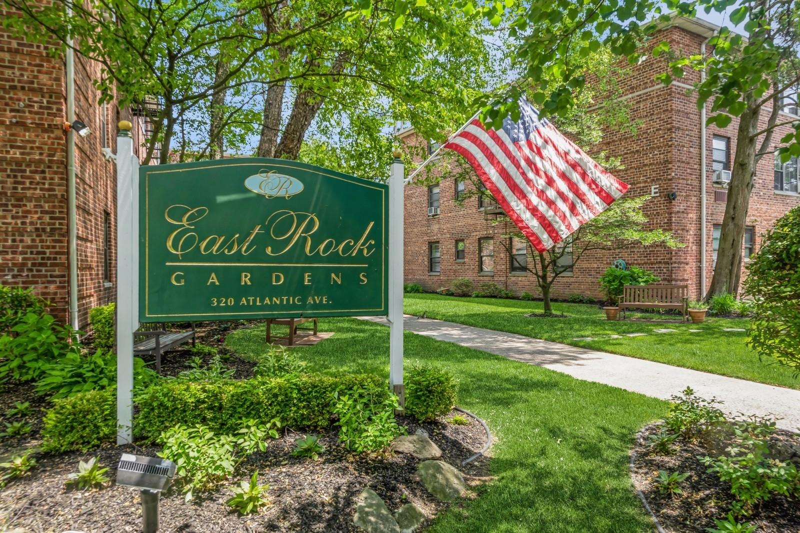 Community / neighborhood sign featuring a lawn